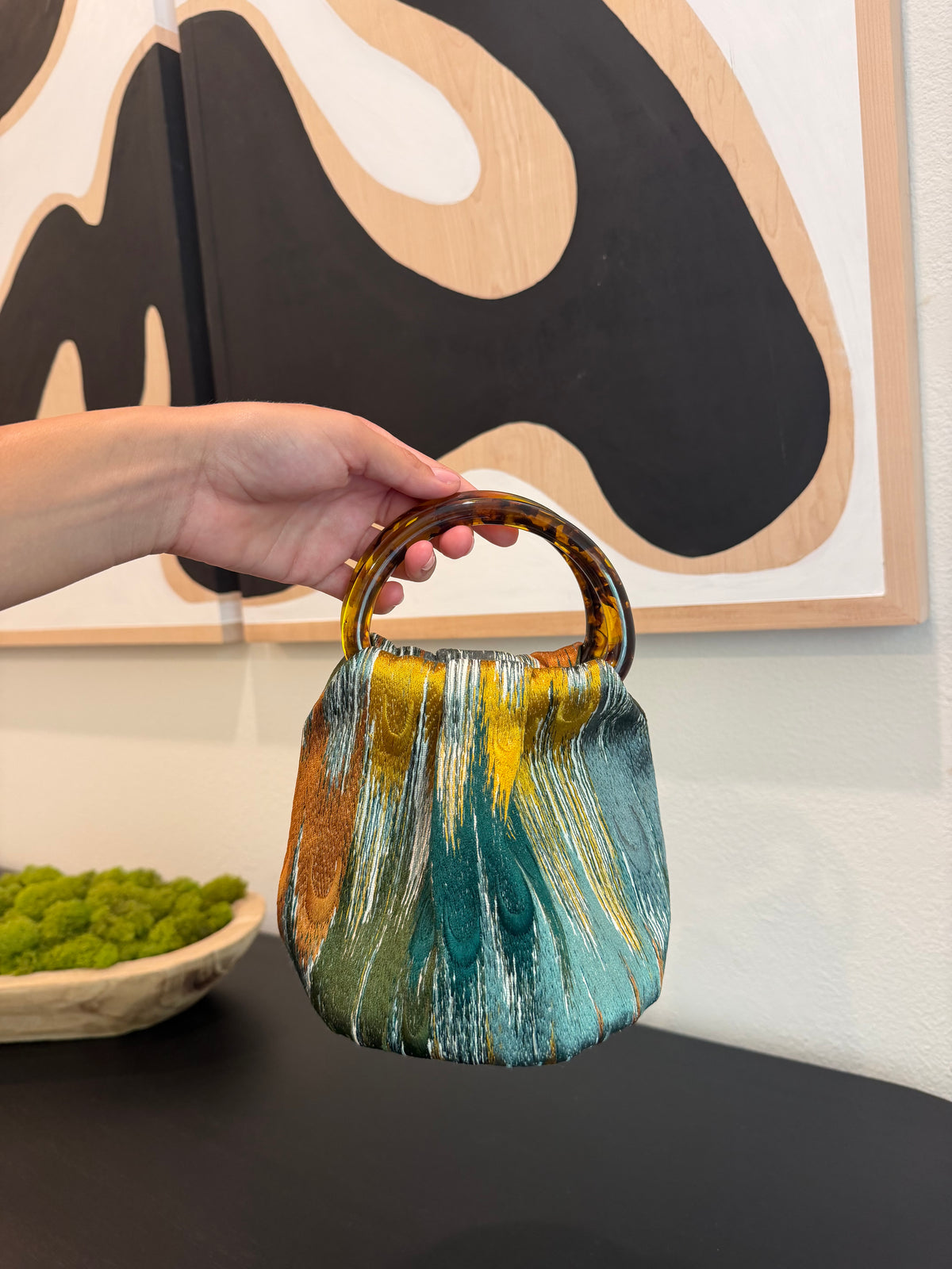 Le Peacock Bag with green satin lining and signature tortoiseshell handles by Du Motra