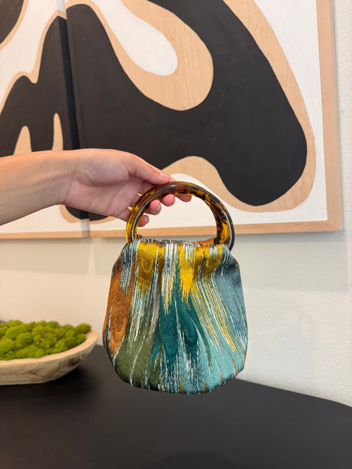 Le Peacock Bag with green satin lining and signature tortoiseshell handles by Du Motra