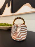 The Daisy Bag in terracotta and cream stripe with tortoiseshell handles, handmade in Los Angeles by Du Motra