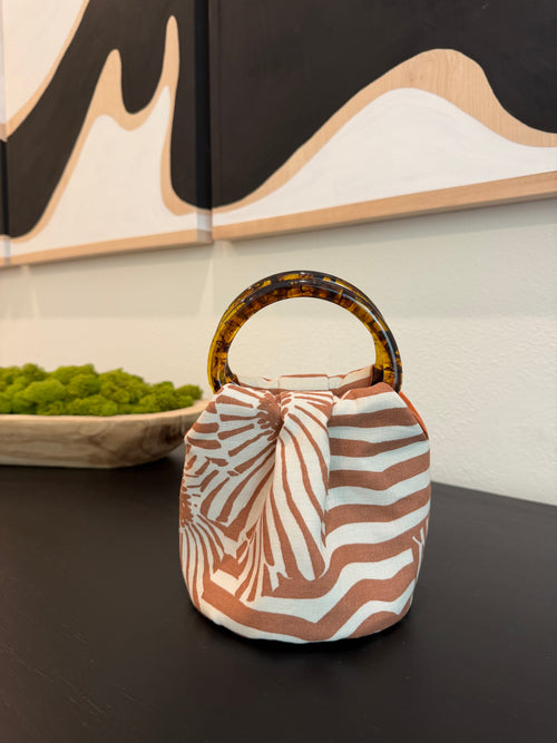 The Daisy Bag in terracotta and cream stripe with tortoiseshell handles, handmade in Los Angeles by Du Motra
