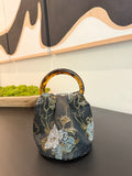 The Indigo Bag in indigo floral jacquard with tortoiseshell handles, handmade in Los Angeles by Du Motra